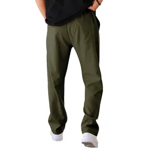 Detailed view of men's loose straight-leg casual pants in olive green color tone.