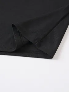 Close-up of black jacquard polo shirt fabric showing texture and stitching