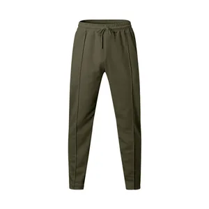 Detailed view of dark olive joggers with elastic drawstring waist and vertical seams.