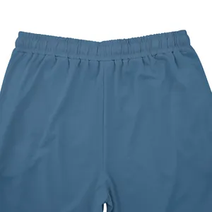 Close-up of the elastic waistband and fabric texture on men's blue sports sweatpants