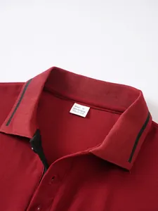 Close-up view of a men's burgundy jacquard polo shirt collar with size M internal tag