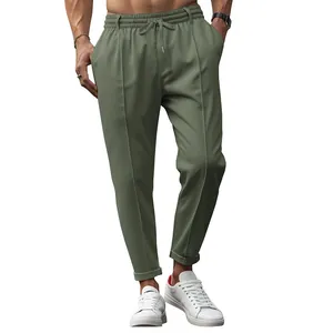 Close-up detail of men's olive green slim fit business casual pants with drawstring
