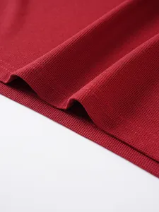 Close-up macro shot of the red jacquard knit fabric texture on a men's Polo shirt