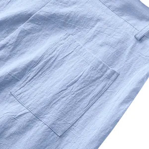 Gros plan sur la texture en lin bleu clair et la poche arrière d'un pantalon décontracté