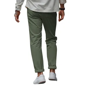 Back view detail of men's olive green slim-fit casual business trousers paired with white sneakers.