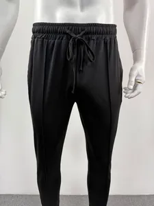 Front view detail of black men's sports sweatpants on a mannequin with drawstring waist