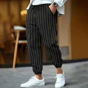 Detailed view of men's striped linen pants with white drawstring and pinstripe pattern