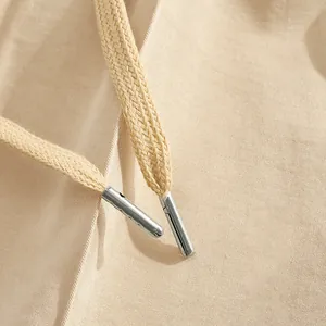 Detailed macro shot of men's casual pants drawstring featuring silver metal tips.