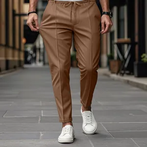 Detail view of men's brown slim-fit casual pants featuring elastic stretch fabric