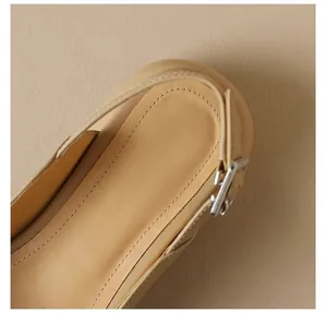 Detailed view of beige sandal cushioned insole and adjustable silver buckle strap