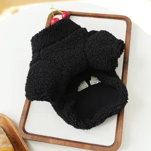 Detail of black sherpa pet jacket showing soft texture and inner lining.