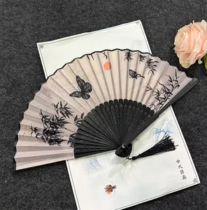 Traditional Chinese folding fan with butterfly and bamboo patterns and tassel detail