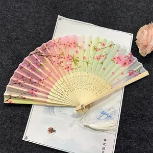 Vintage folding fan with pink floral blossom pattern and bamboo ribs for dancing