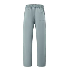 Back view of men's minimalist solid color casual slim fit trousers in light blue