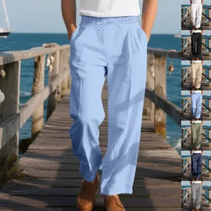 Loose fit men's linen beach trousers in various colors displayed on a coastal pier.