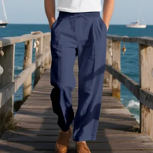 Detailed shot of comfortable blue linen loose casual pants for men on a sunny beach pier