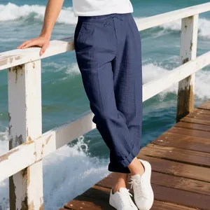 High-quality navy blue linen blend casual wide-leg pants for men shown on a wooden pier.