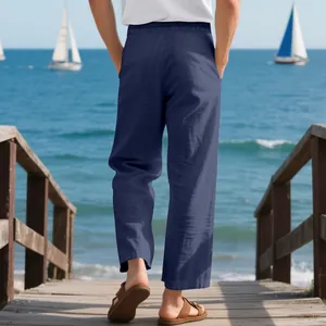 Back view of men's casual loose navy linen wide-leg beach pants walking on a pier