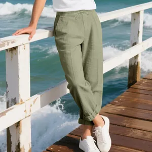 Detailed view of men's loose sage green linen casual pants perfect for beach leisure