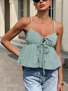 Detailed macro view of green striped camisole top featuring elegant front tie bow