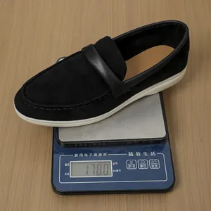 Detailed shot of a lightweight black suede loafer weighing 178g on a digital scale