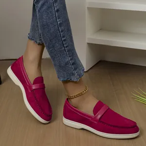 Detail view of wine red suede loafers for women with comfortable flat white soles