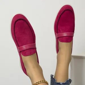 Detailed view of women's fuchsia suede slip-on loafers with decorative strap