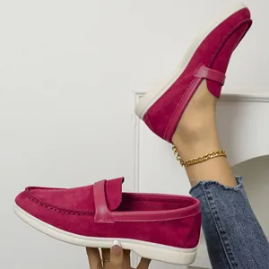 Deep fuchsia suede-style flat loafers featuring white soles and a casual slip-on design