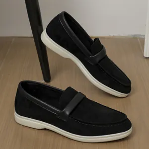 Close-up view of black suede-like slip-on loafers with white soles