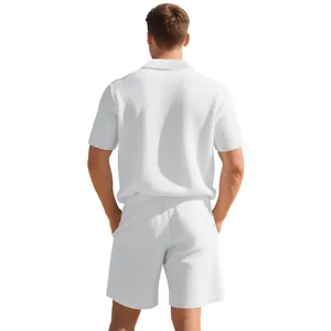 Back view of men's white waffle knit short sleeve polo shirt and matching shorts