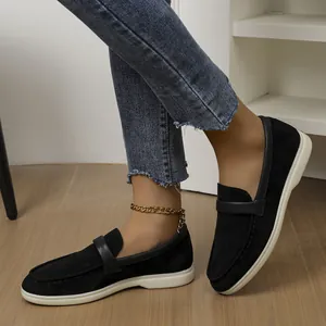 Close-up of comfortable black suede flat loafers for women in a retro British style.