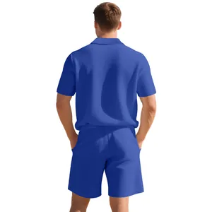 Back view showing texture of men's blue waffle knit short sleeve polo and shorts set.