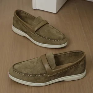Side view of vintage khaki suede loafers with flat white soles and decorative strap