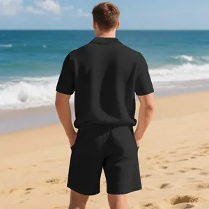 Back view of men's black waffle knit casual polo and shorts set on a sunny beach