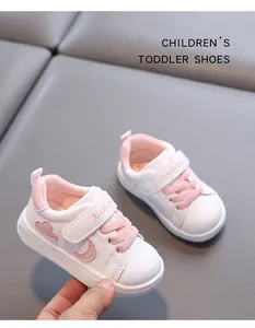Close-up of white and pink toddler shoes with waterproof leather and soft sole.