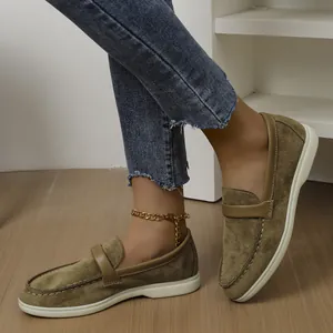 Macro detail of women's olive green suede slip-on loafers with retro British style