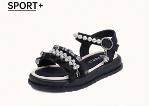 Detailed view of girls' black princess sandals with elegant pearl embellishments and ruffles.