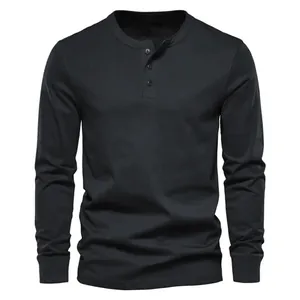 High quality front view detail of a men's slim fit black long sleeve Henley T-shirt.