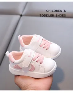 Detail view of cute white and pink toddler walking shoes with soft leather finish