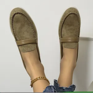 Stylish olive green suede flat loafers for women, showcased with a gold chain anklet