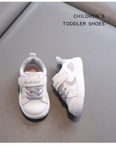 Detailed view of white toddler walking shoes with grey heart and moon design for kids