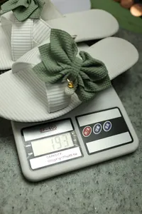 Close-up view of lightweight women's summer bow sandals weighing 193g on a digital scale