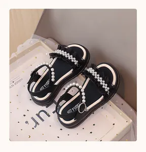 Detail view of girls princess sandals with pearls and lace straps for summer season