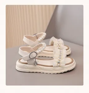 Detail view of girls' princess sandals featuring pearls and ruffles decorations