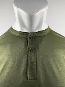 Detail view of men's olive green Henley shirt neckline with textured button placket