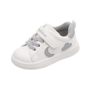 White baby walking shoes with soft sole, waterproof leather and cute moon cloud pattern