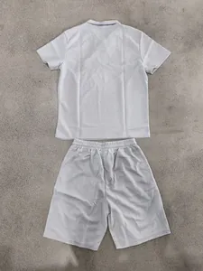 Detailed view of men's summer waffle knit polo shirt and casual shorts set in light grey.