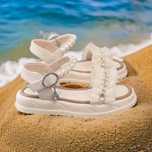 Elegant girl's beige beach sandals with pearls and ruffle details