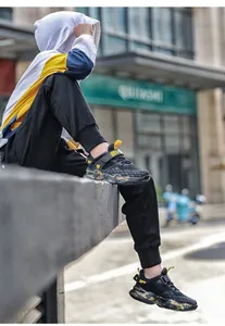 Primo piano di scarpe da ginnastica traspiranti da bambino con suole mimetiche alla moda