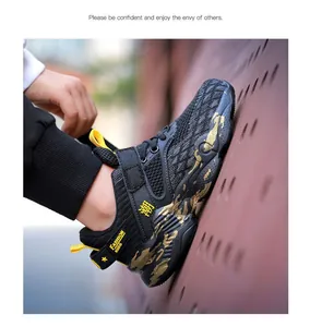 Dettaglio vista laterale di scarpe sportive traspiranti da bambino in nero e oro alla moda